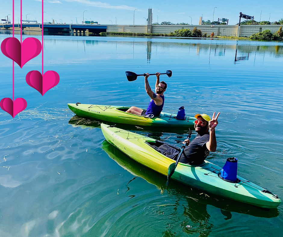 2 guys in kayaks celebrate love