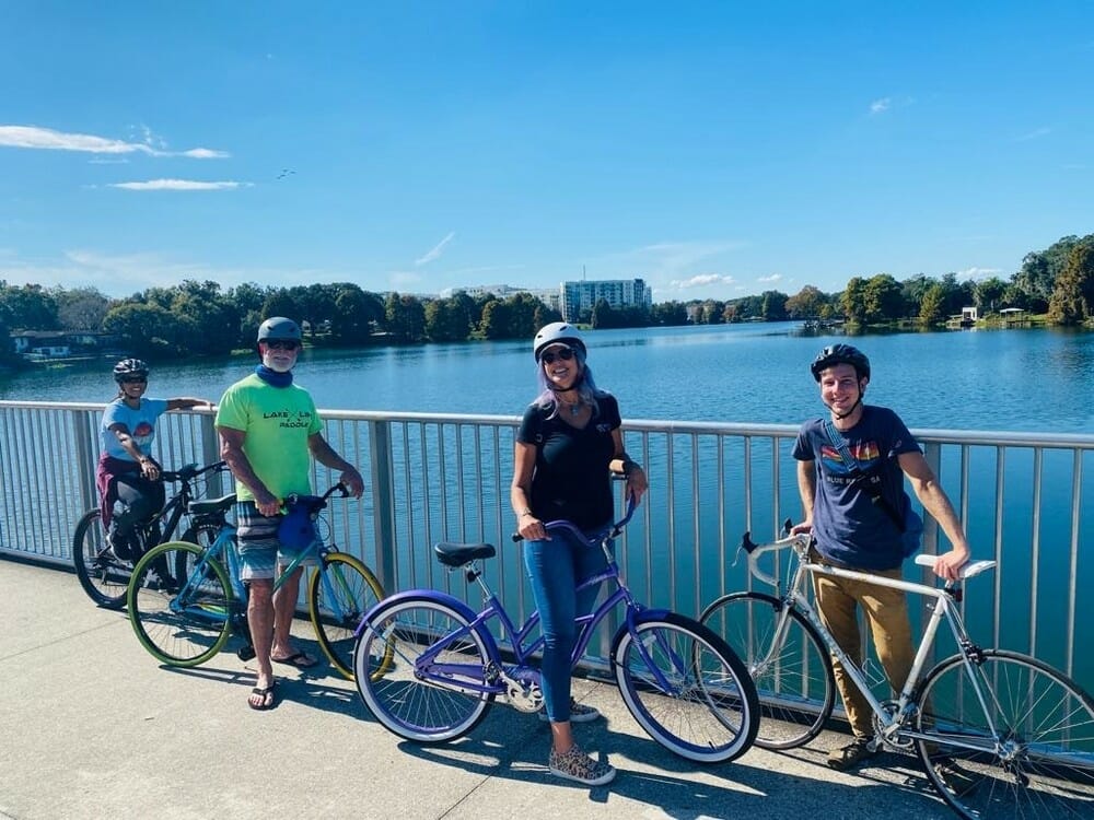 Bike riders on bridge overlooking lake