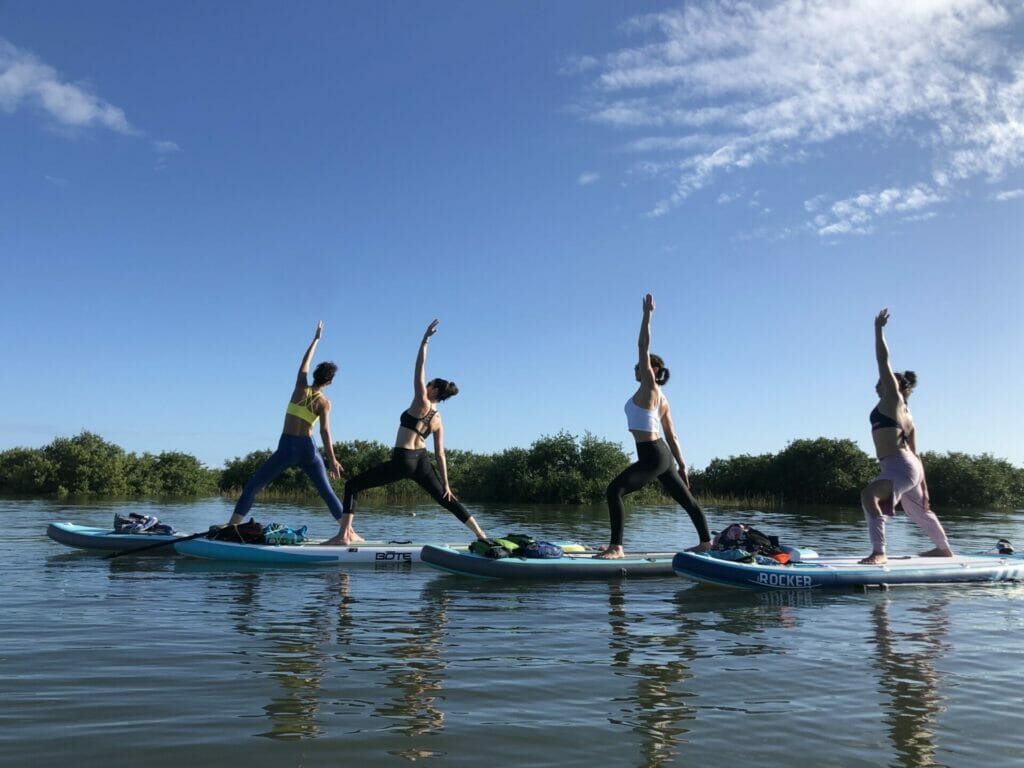 Women doing paddleboard yoga in Orlando