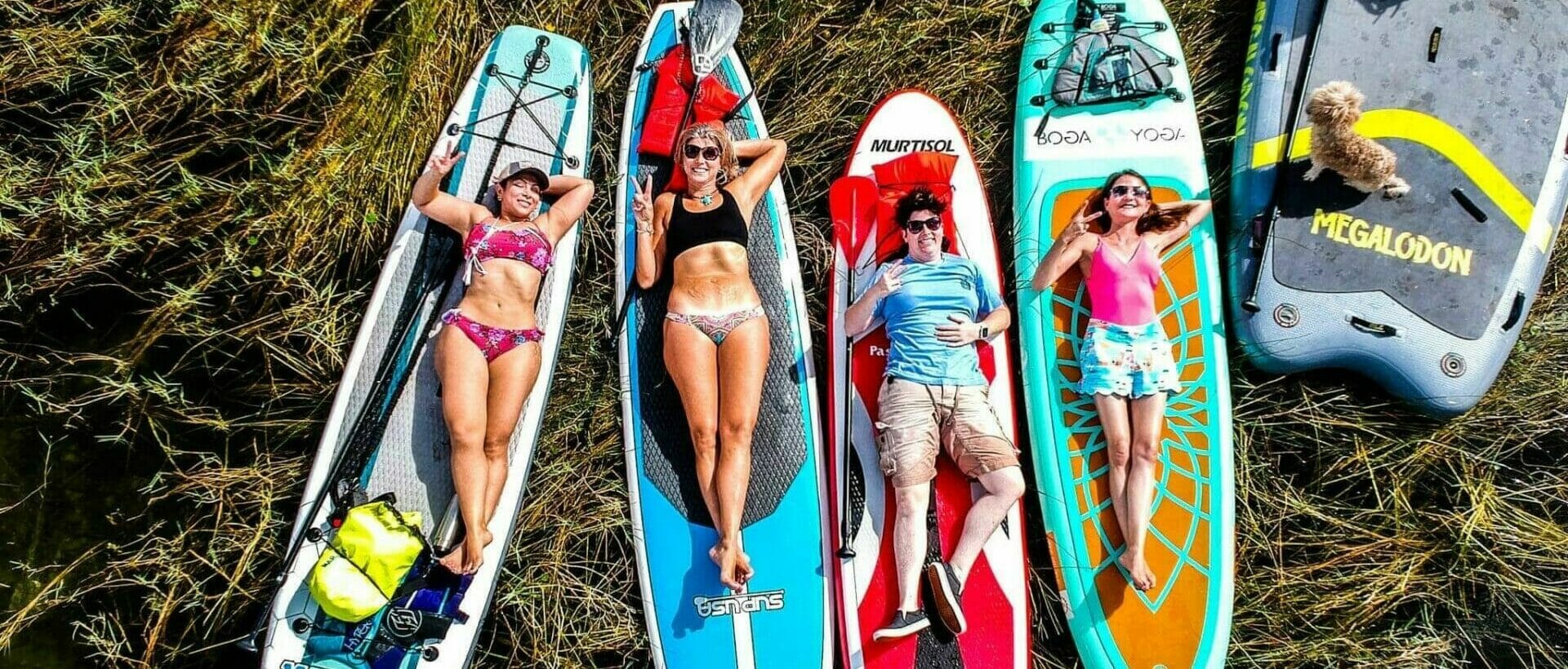 Overhead girls lying on paddleboards